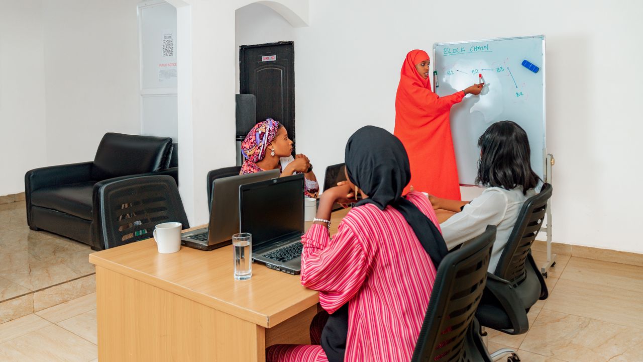 Services Group of women attending a technology class with a focus on blockchain.