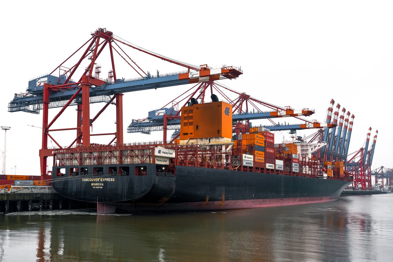 Vivid scene of container ships and cranes at the bustling Hamburg Port in Germany.
